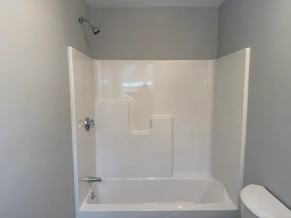 a bathroom with a shower and a bath tub
