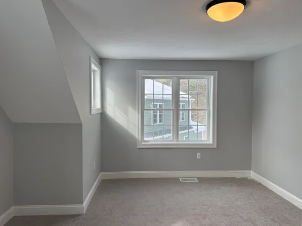 an empty room with windows and closet
