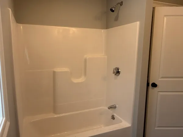 a bathroom with a shower and a bath tub