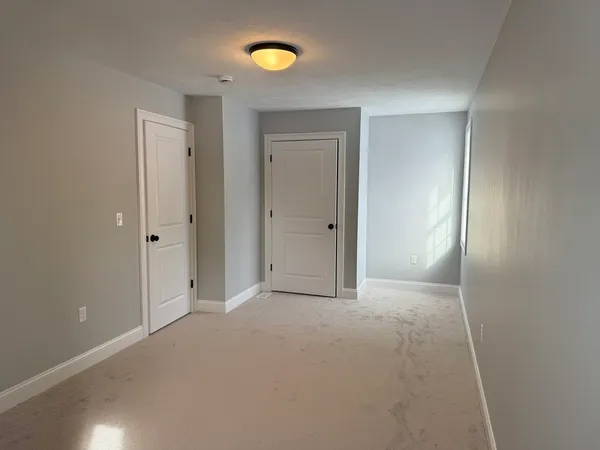 a view of an empty room with a bathroom