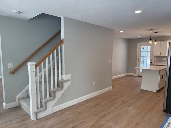 a view of kitchen with furniture and wooden floor