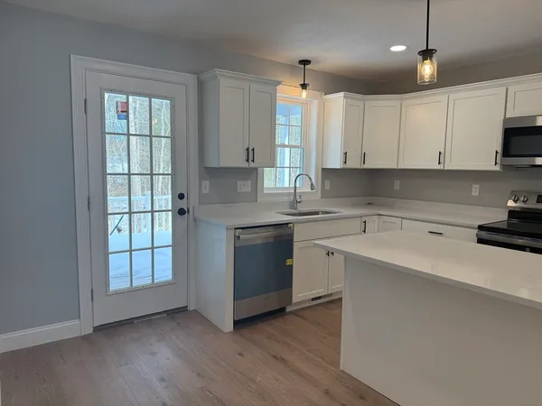 a kitchen with a sink window and cabinets