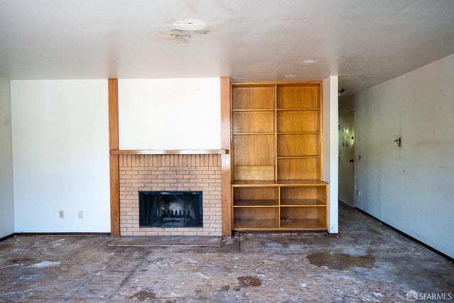 a view of a room with a fireplace