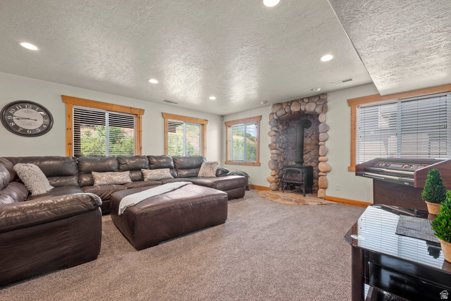288 South Hillside Drive Elk Ridge, UT 84651 - Photo 15 of 27 Massive windows offer natural light in the basement with a wood burning stove and custom wood trim