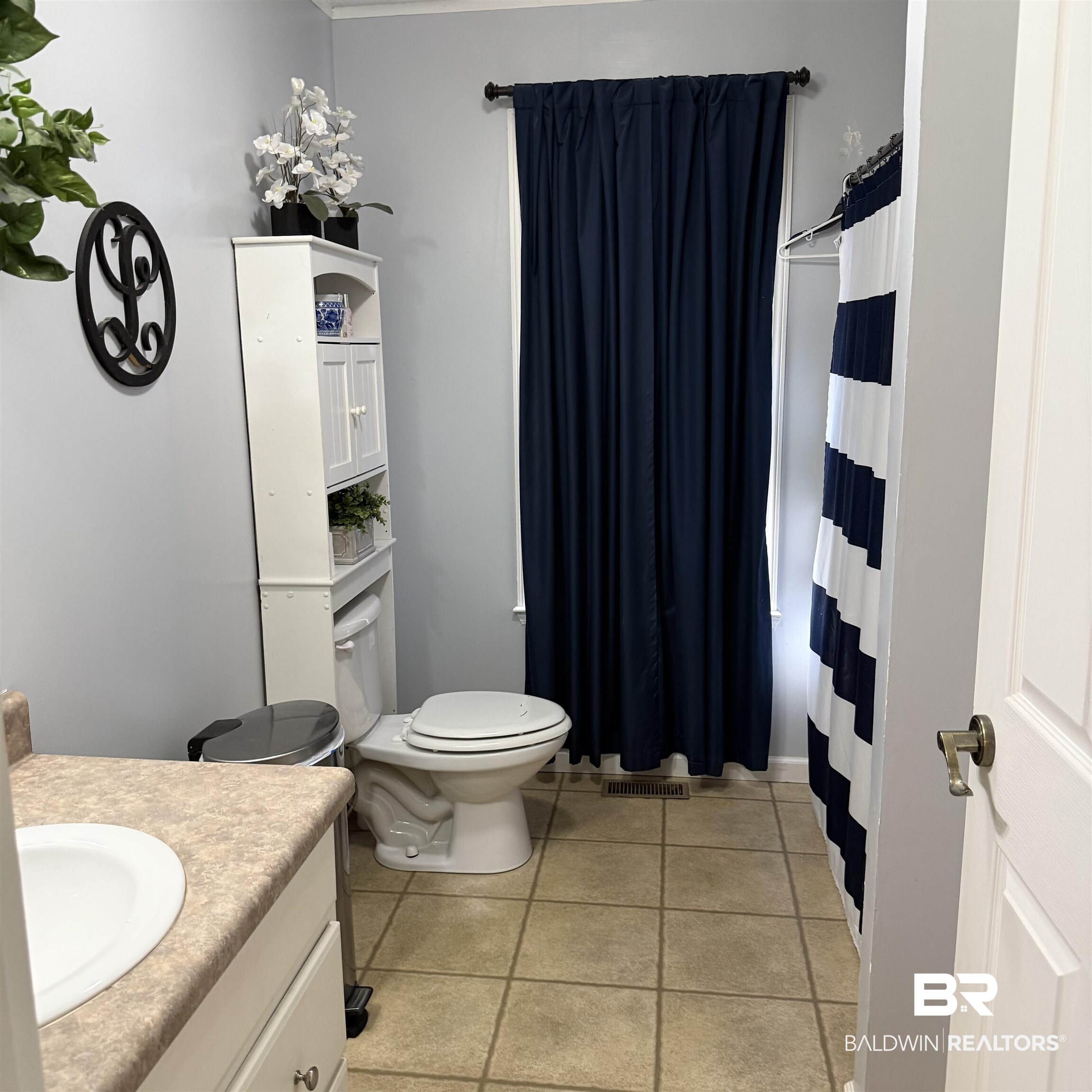 447 Sugar Hill Road Monroeville, AL 36460 - Photo 13 of 27 Full bath featuring vanity, curtained shower, and light tile patterned floors