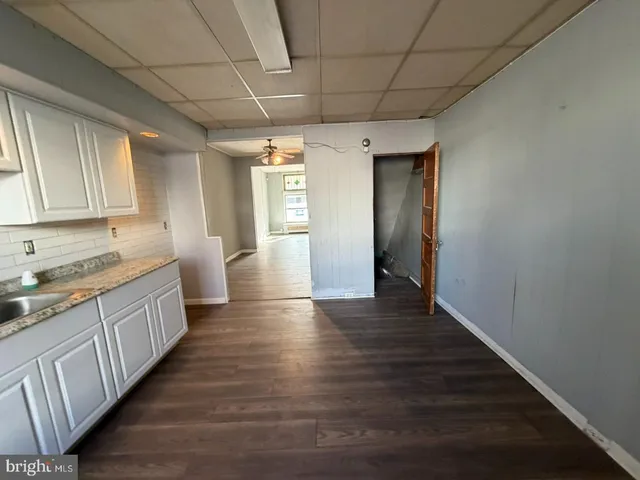a view of a kitchen with a sink and cabinets