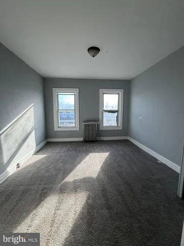 a view of a livingroom with an empty space and chair