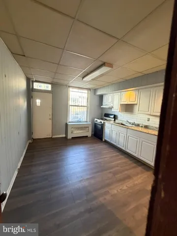 a view of hallway with wooden floor