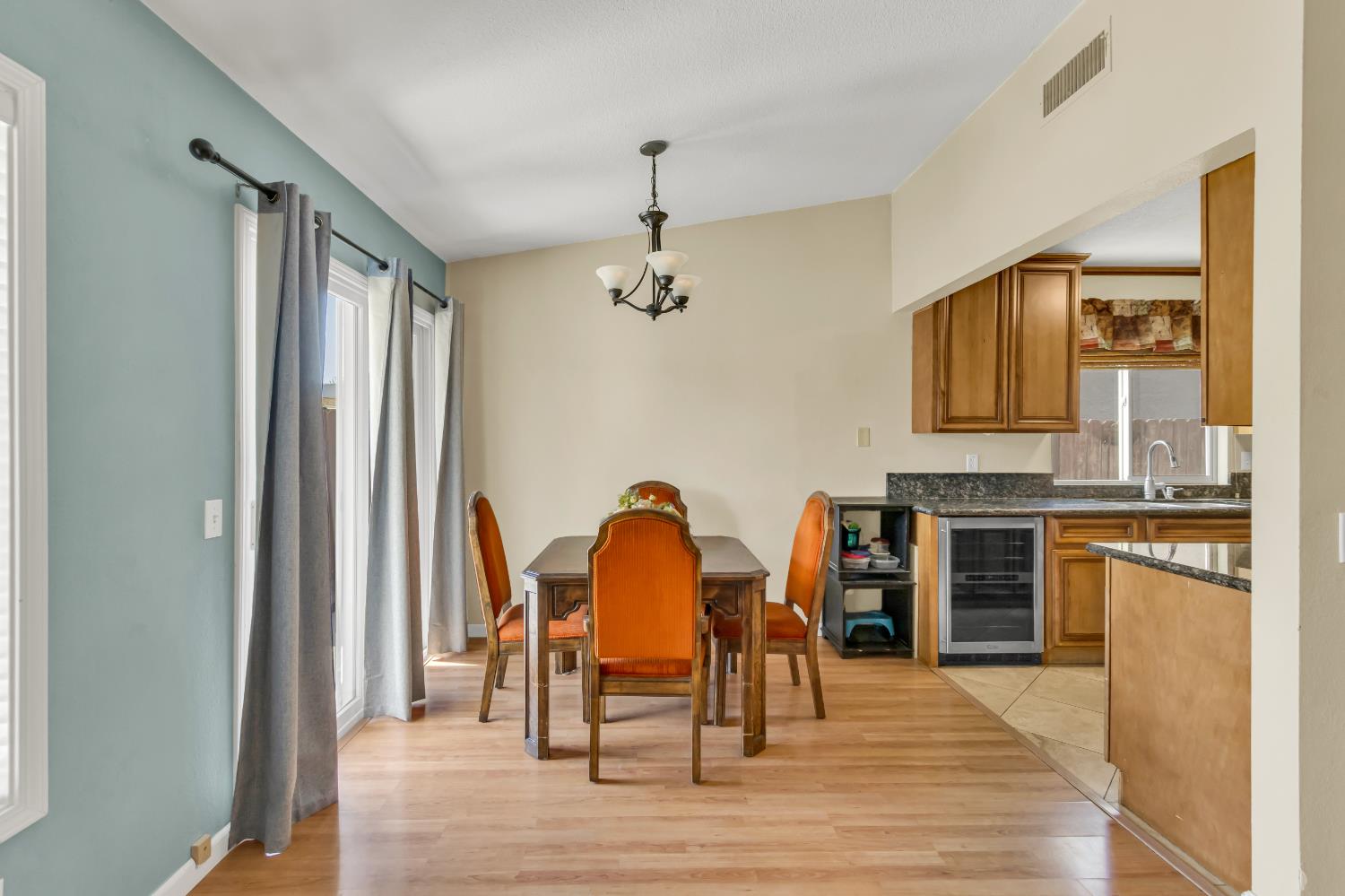 8069 Cornerstone Way Citrus Heights, CA 95621 - Photo 17 of 27 a dining room with furniture a chandelier and wooden floor