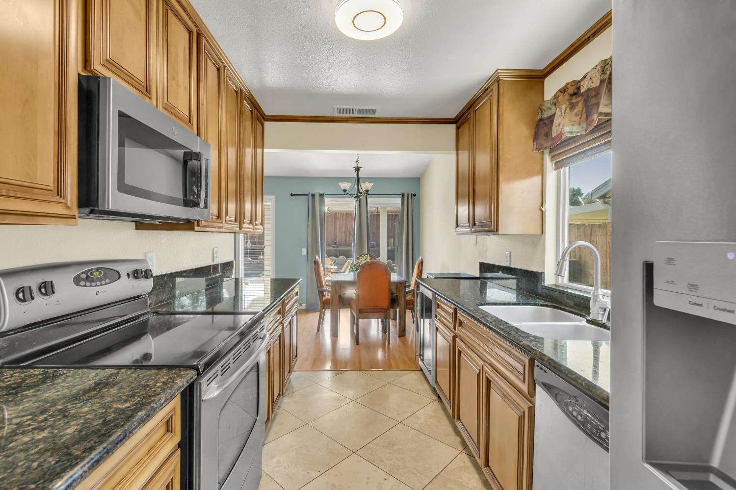 8069 Cornerstone Way Citrus Heights, CA 95621 - Photo 18 of 27 a kitchen with stainless steel appliances granite countertop a sink stove and cabinets