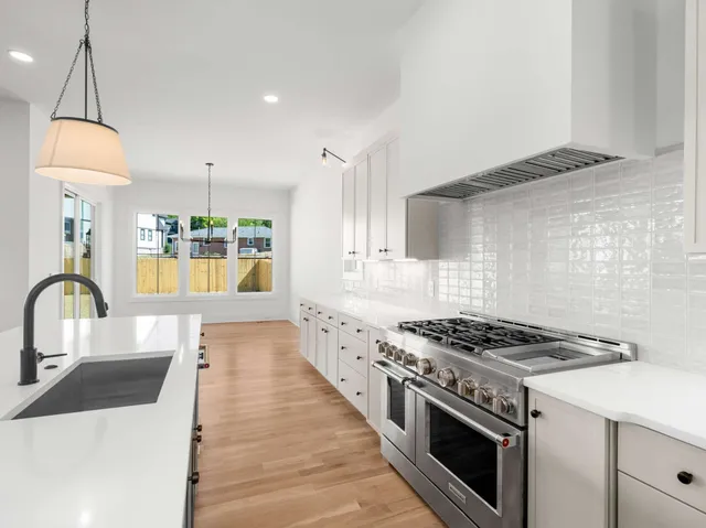 a kitchen with stove and cabinets