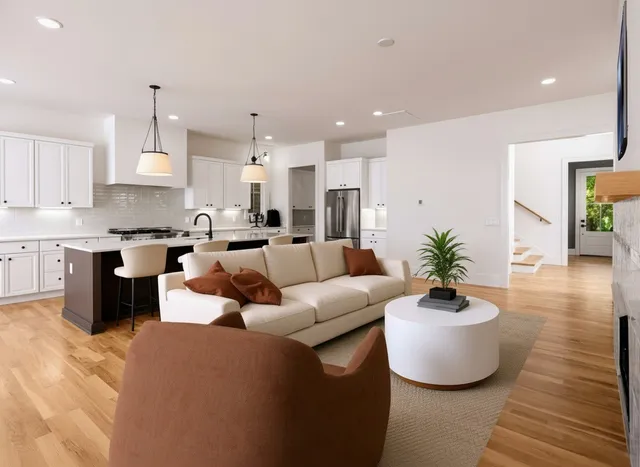 a living room with furniture kitchen and a chandelier