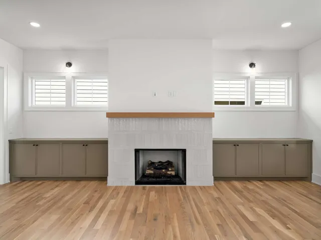 a room with a fireplace and window