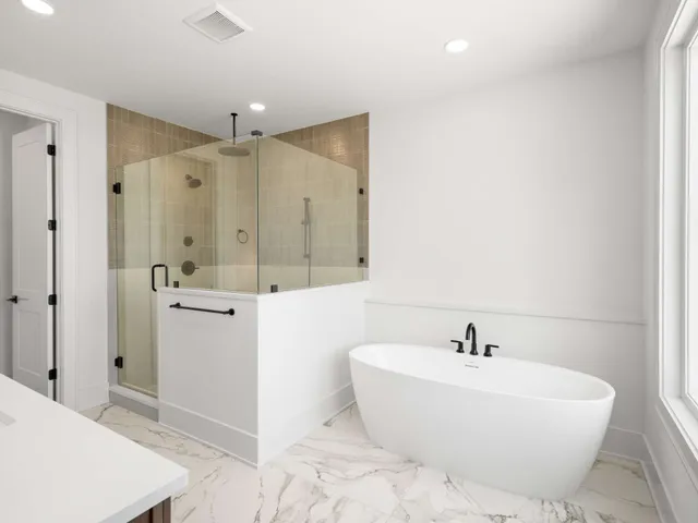 a bathroom with a bathtub and shower