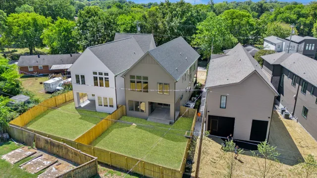 an aerial view of a house with swimming pool and furniture