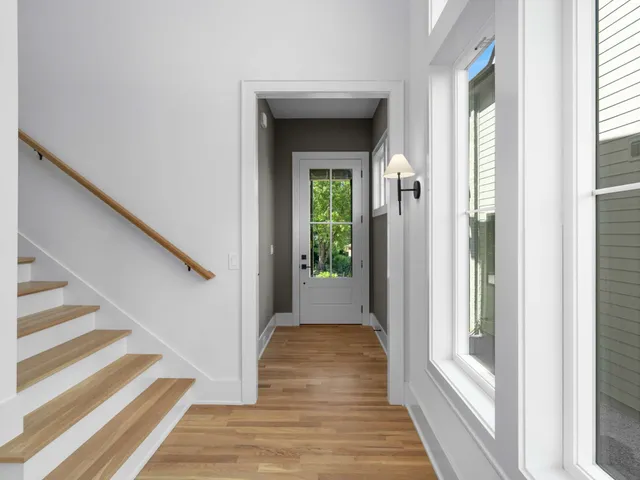a view of a hallway with wooden floor and entryway