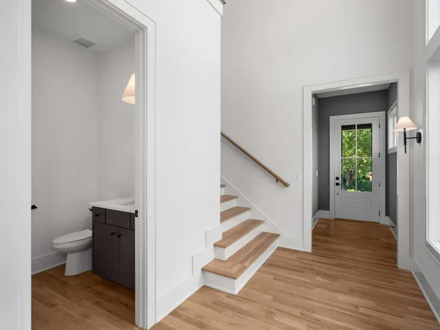 a view of a hallway with wooden floor and entryway