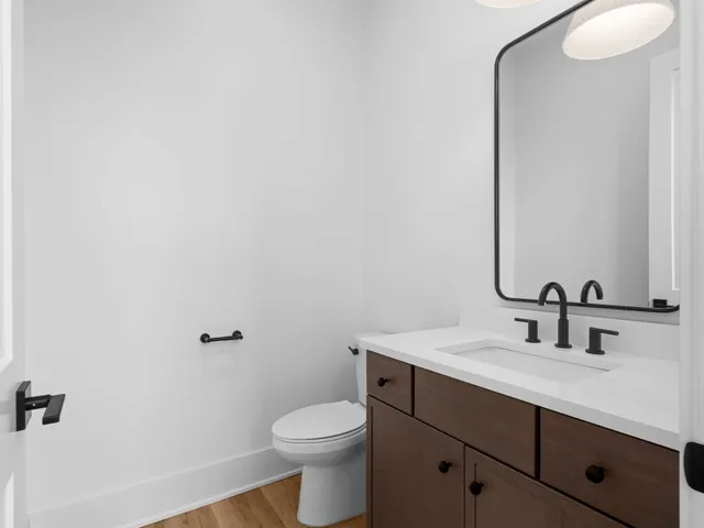 a bathroom with a sink a toilet and mirror
