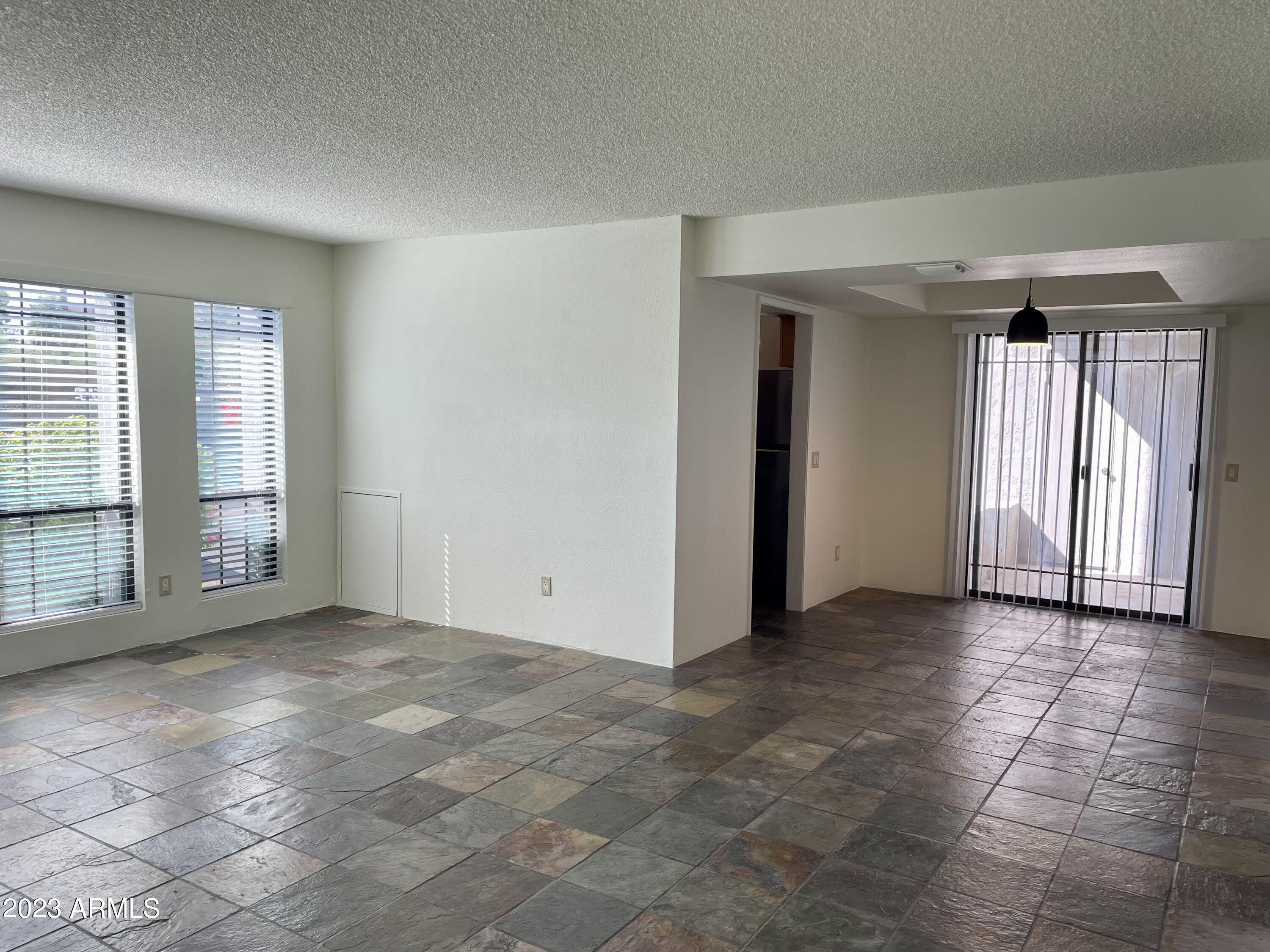 5203 North 24th Street, Unit 102 Phoenix, AZ 85016 - Photo 3 of 12 an empty room with windows and closet