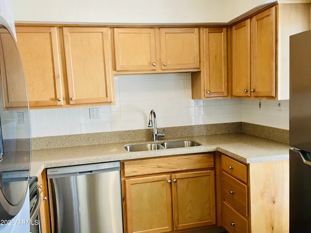 a kitchen with stainless steel appliances granite countertop a sink and a cabinets