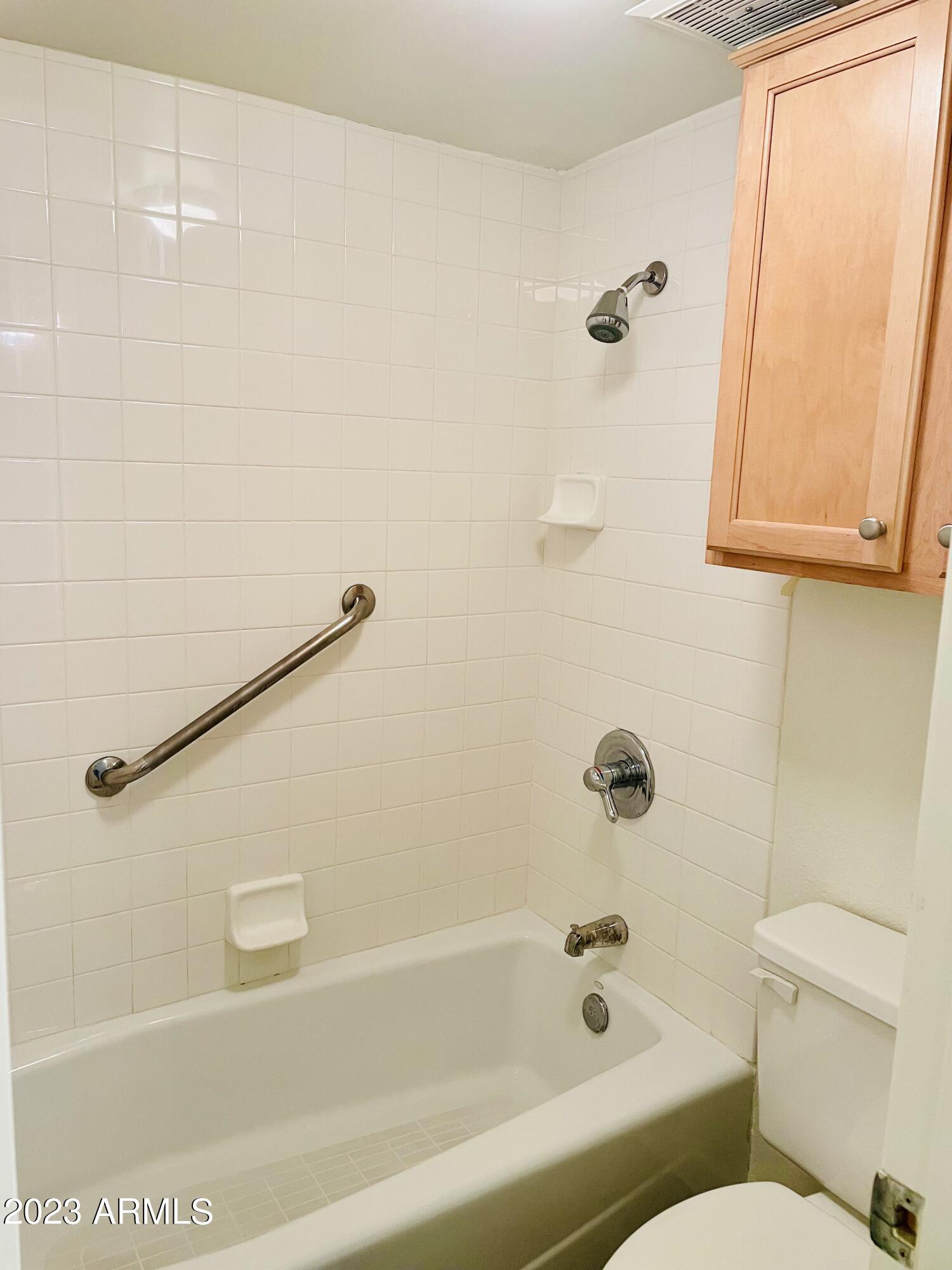 5203 North 24th Street, Unit 102 Phoenix, AZ 85016 - Photo 9 of 12 a bathroom with a shower and a bathtub