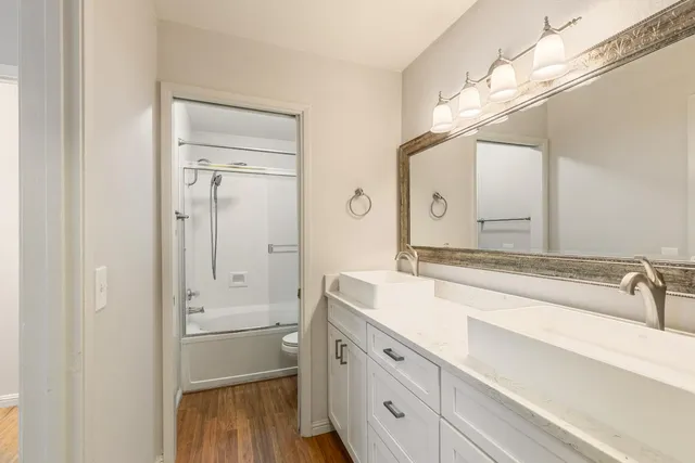 a spacious bathroom with a granite countertop sink mirror and double