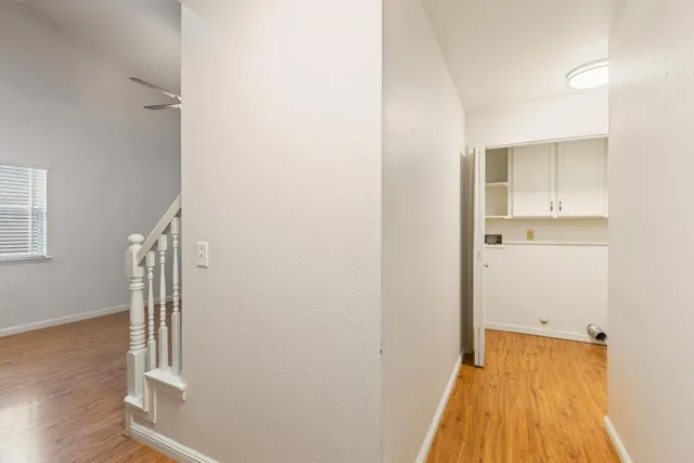 a view of hallway with wooden floor