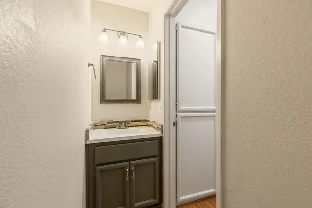 a bathroom with a sink a toilet and mirror