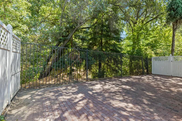 a view of a house with backyard and wooden fence