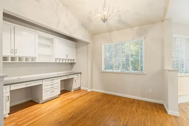 a view of a kitchen with a stove cabinets and wooden floor