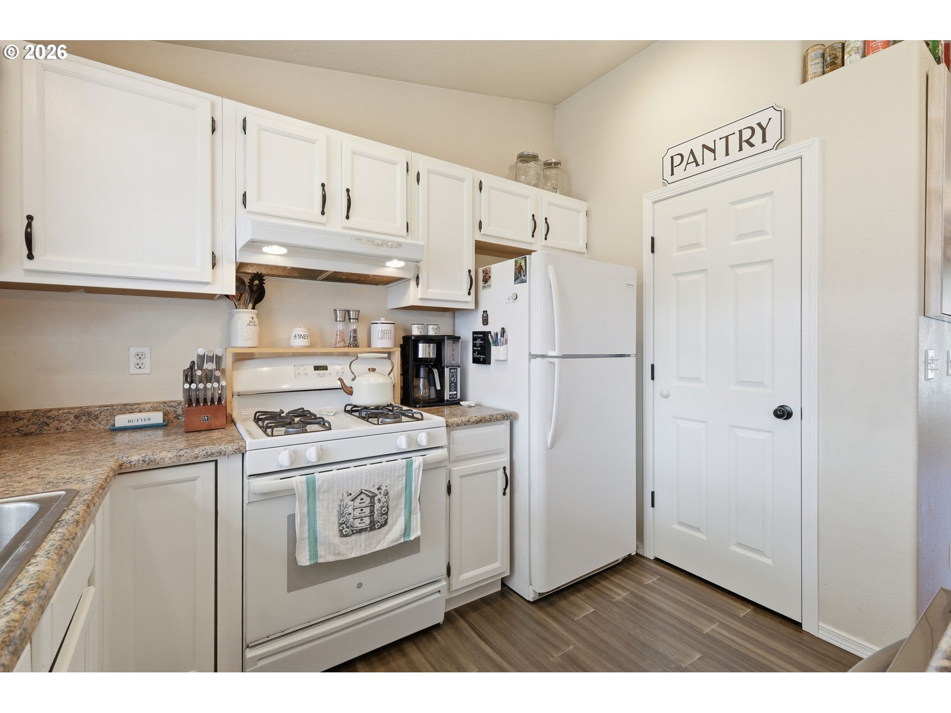 2075 Bryant Avenue Cottage Grove, OR 97424 - Photo 12 of 29 a kitchen with a refrigerator a stove a microwave and cabinets