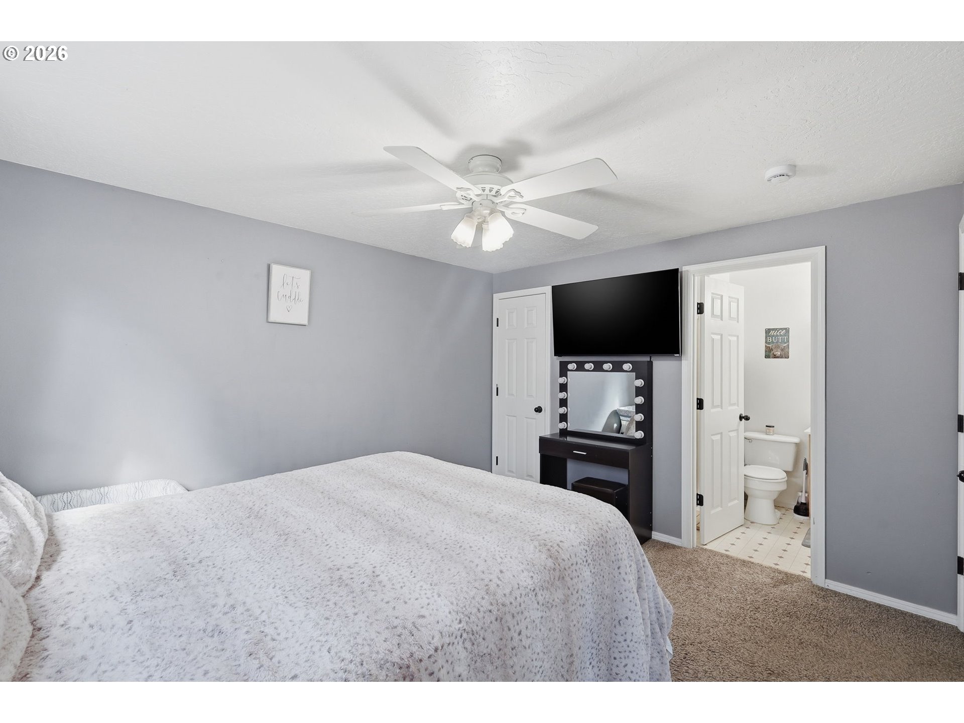 2075 Bryant Avenue Cottage Grove, OR 97424 - Photo 19 of 29 a bedroom with a large bed and a flat tv screen on dresser