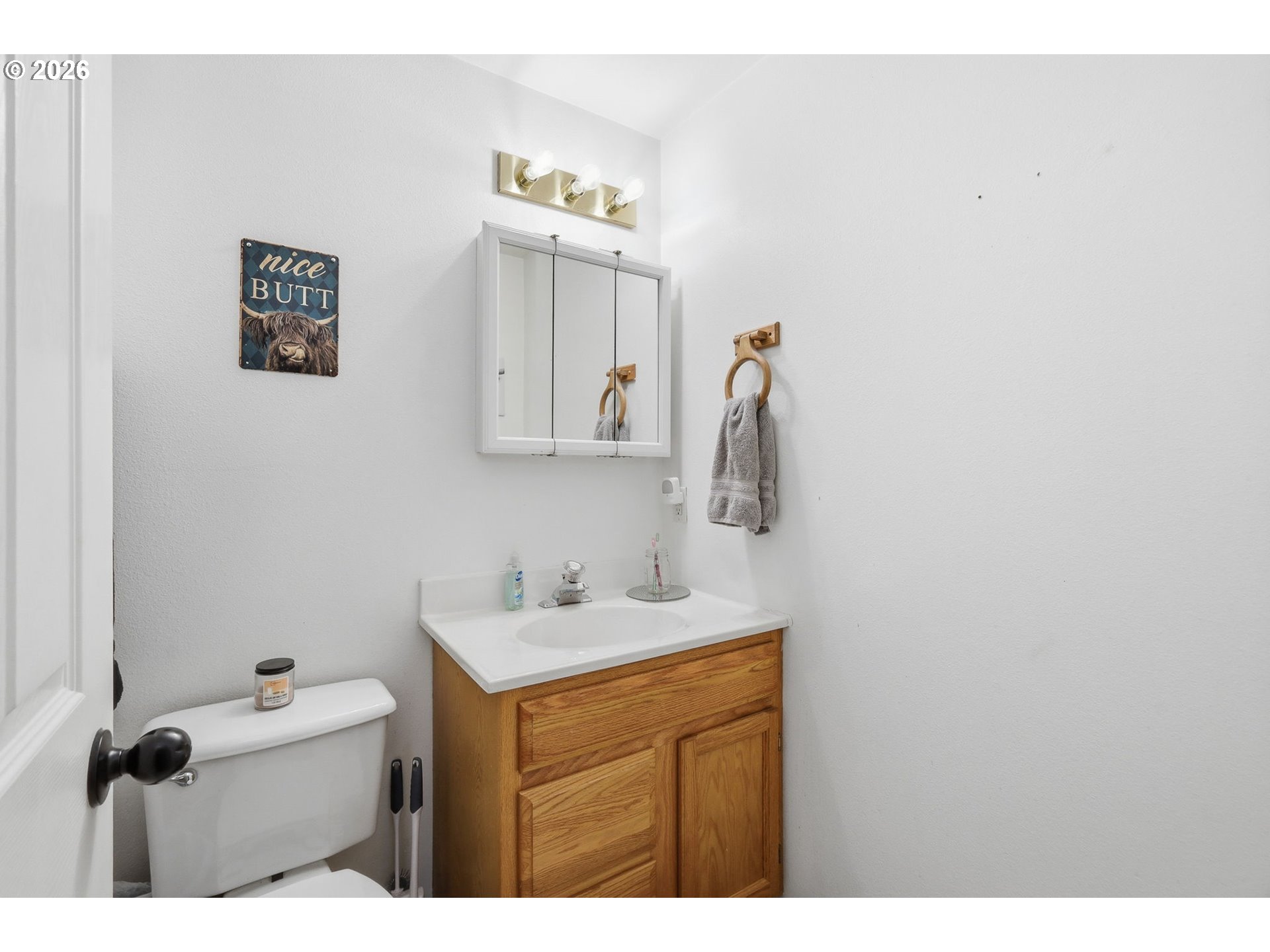 2075 Bryant Avenue Cottage Grove, OR 97424 - Photo 20 of 29 a bathroom with a sink a mirror and a toilet