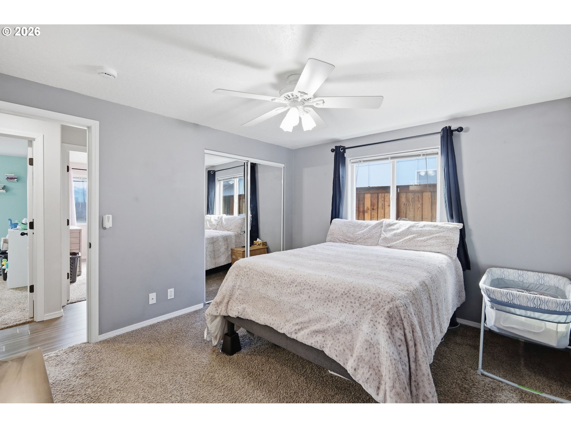 2075 Bryant Avenue Cottage Grove, OR 97424 - Photo 22 of 29 a bedroom with a bed and a chandelier