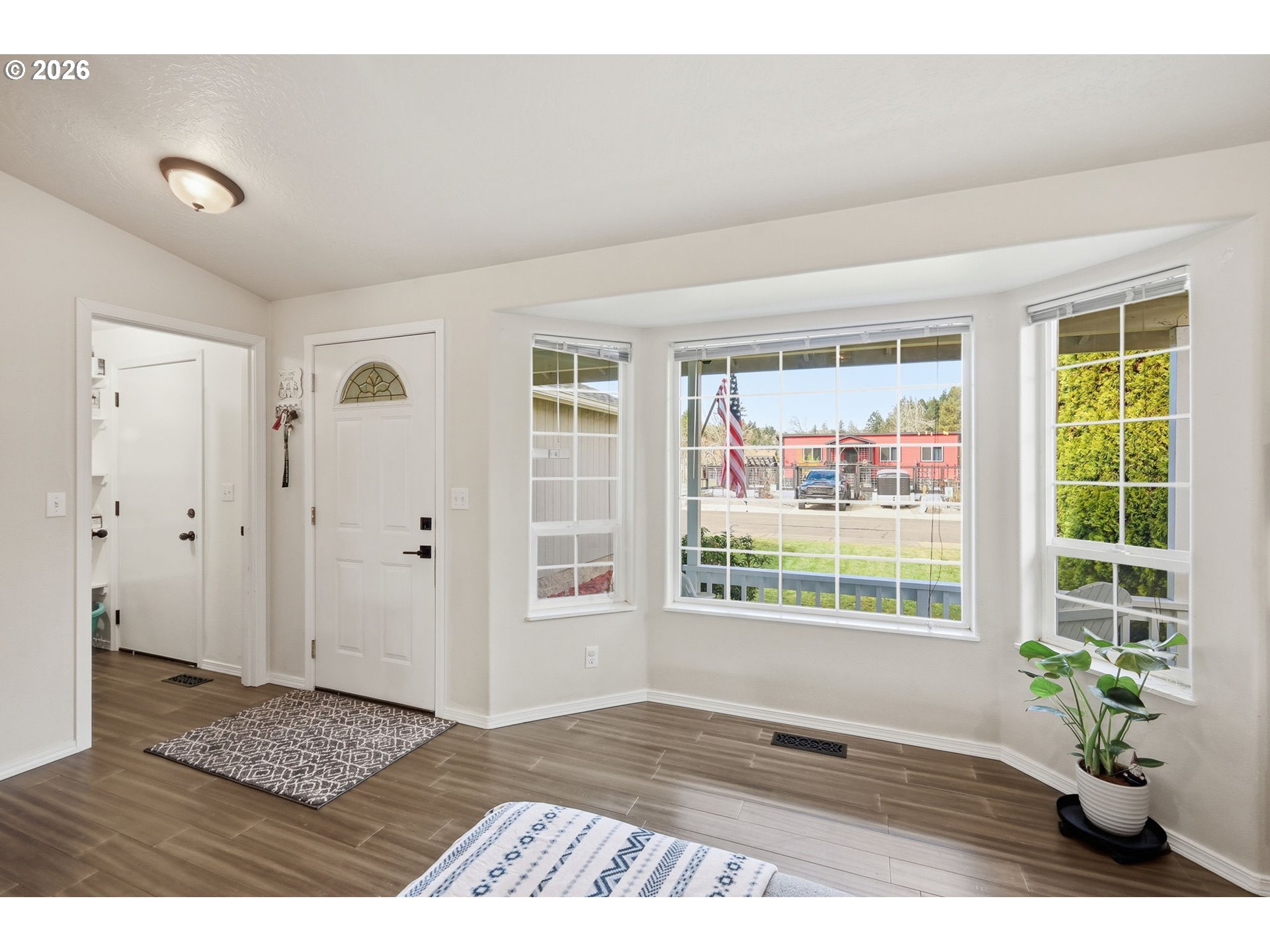 2075 Bryant Avenue Cottage Grove, OR 97424 - Photo 4 of 29 a view of an empty room with wooden floor and a window