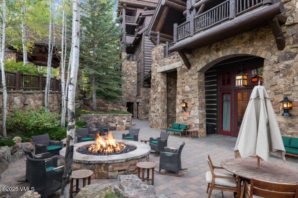 a backyard of a house with fountain table and chairs