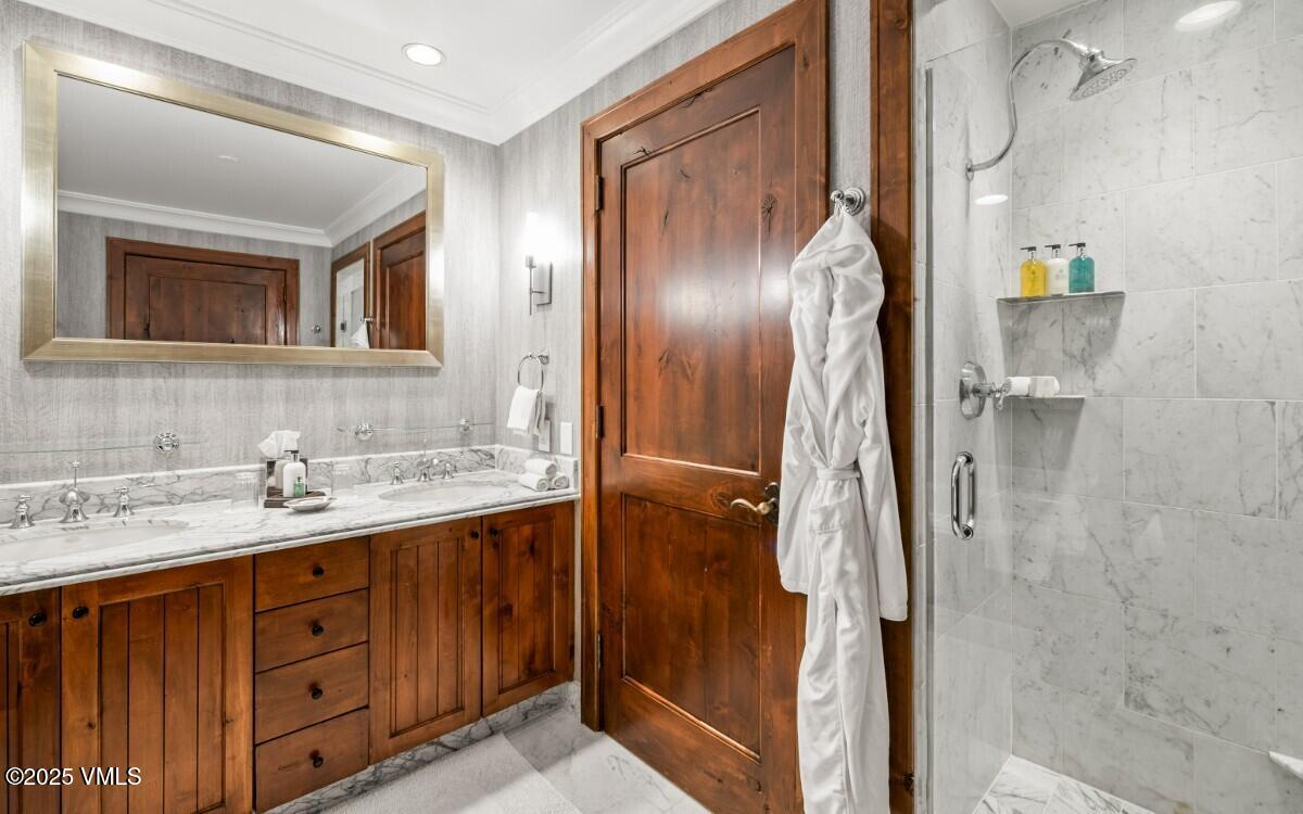 100 Bachelor Ridge Road, Unit 3508/09 Avon, CO 81620 - Photo 12 of 33 a bathroom with a granite countertop sink a mirror and shower