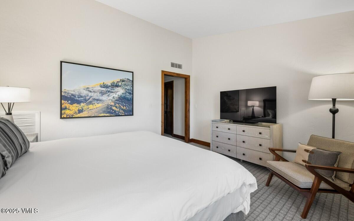 100 Bachelor Ridge Road, Unit 3508/09 Avon, CO 81620 - Photo 15 of 33 a bedroom with a bed and a flat screen tv