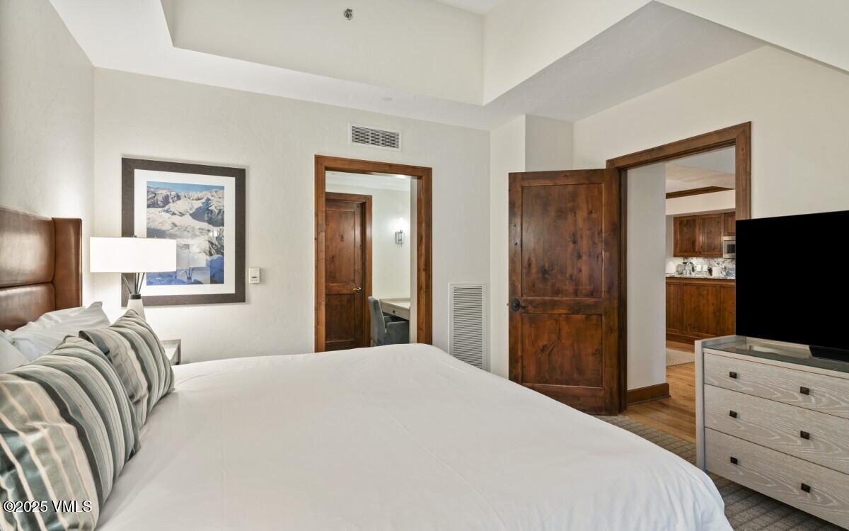 100 Bachelor Ridge Road, Unit 3508/09 Avon, CO 81620 - Photo 9 of 33 a bedroom with a bed and a flat screen tv