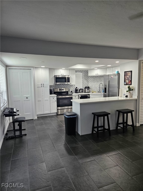 a kitchen with a sink and chairs
