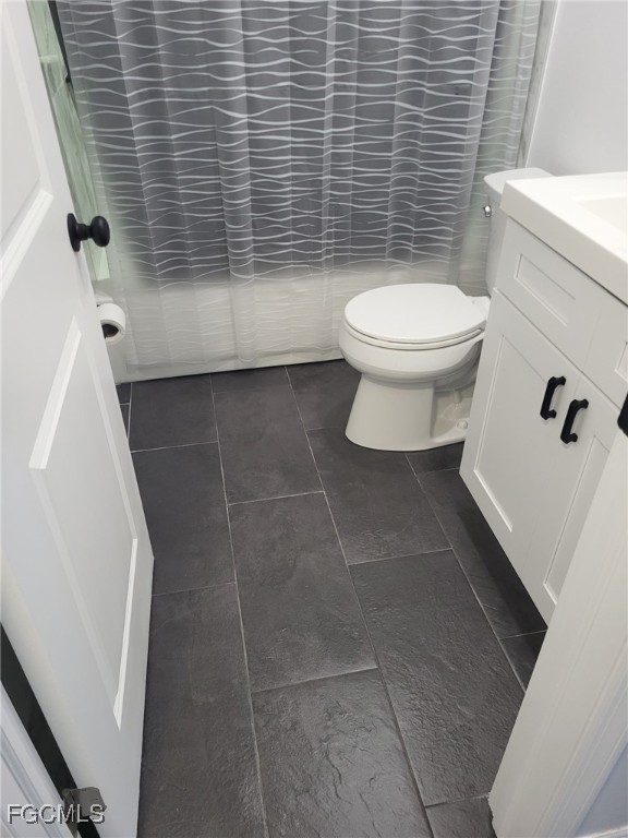 5028 Chiquita Boulevard South, Unit 101 Cape Coral, FL 33914 - Photo 5 of 7 a bathroom with a toilet and a shower