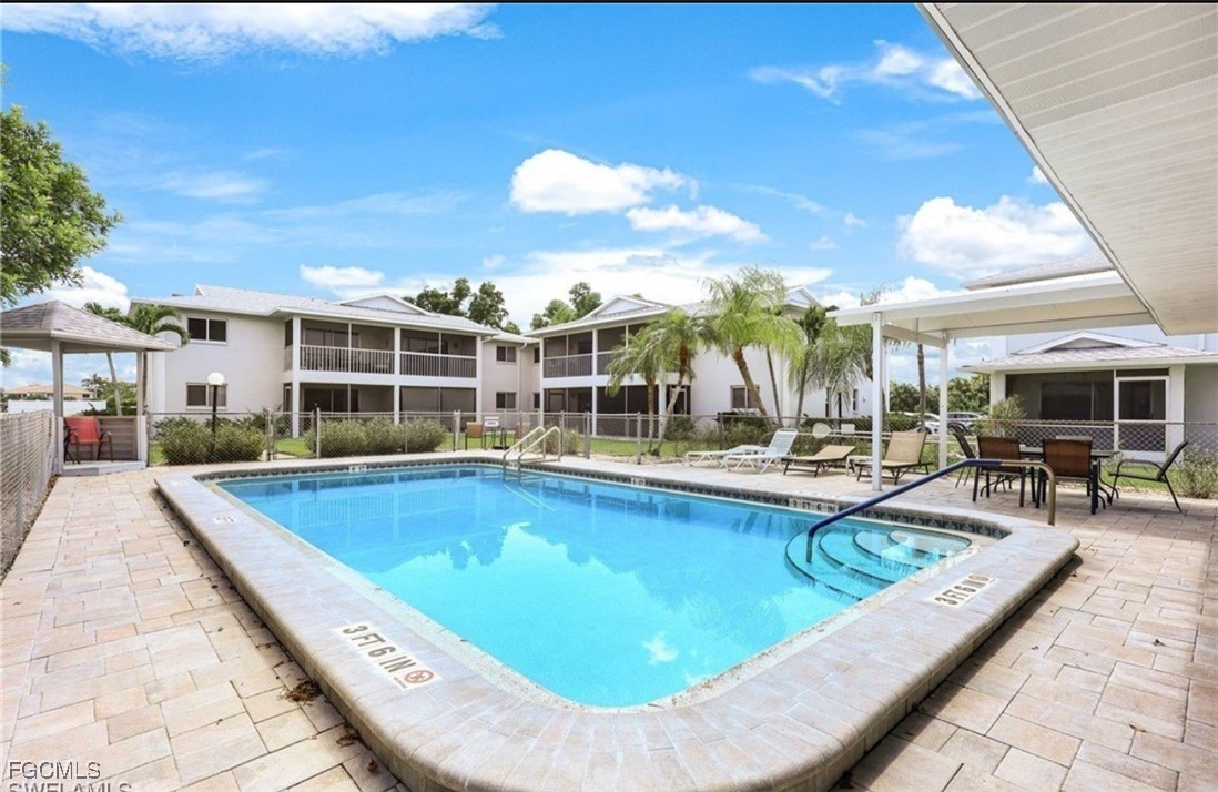 5028 Chiquita Boulevard South, Unit 101 Cape Coral, FL 33914 - Photo 7 of 7 a view of a swimming pool with outdoor seating