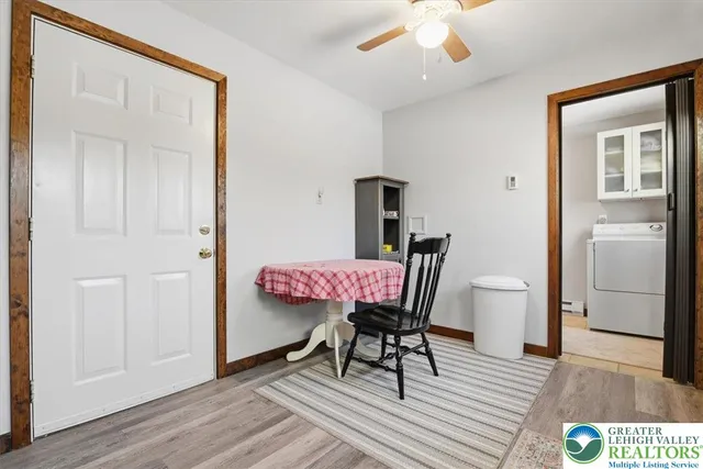a dining room with furniture and wooden floor