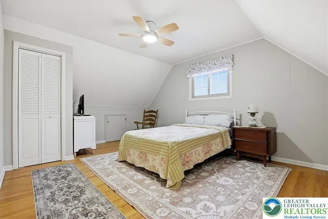 a spacious bedroom with a bed and a chandelier