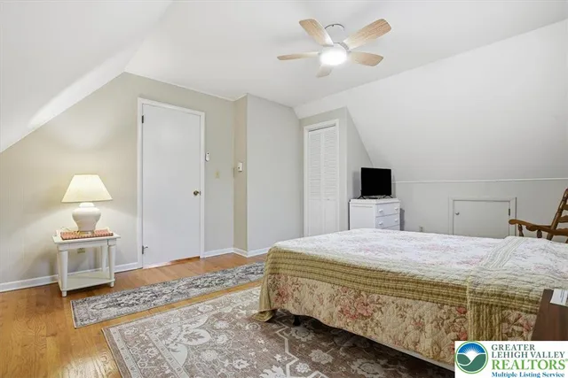 a bedroom with a bed and a lamp on table