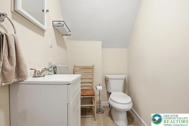 a bathroom with a toilet a sink and a mirror