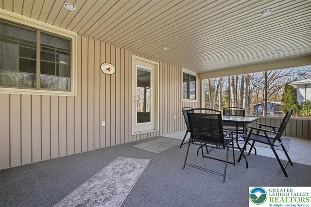 a view of a patio with table and chairs and potted plants