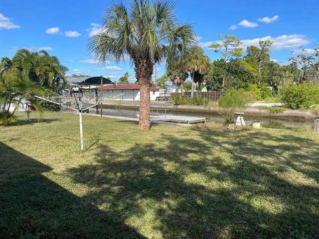 a swimming pool with outdoor seating and yard