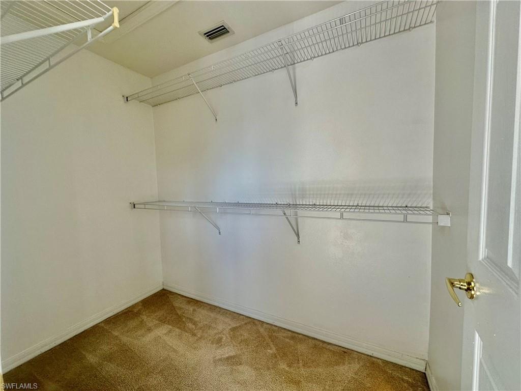 996 Hampton Circle, Unit 71 Naples, FL 34105 - Photo 12 of 30 a view of a room with racks on the wall