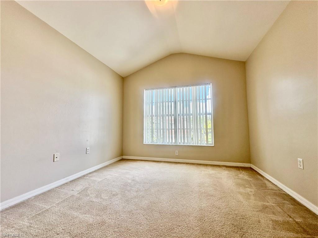 996 Hampton Circle, Unit 71 Naples, FL 34105 - Photo 17 of 30 an empty room with a empty space and windows